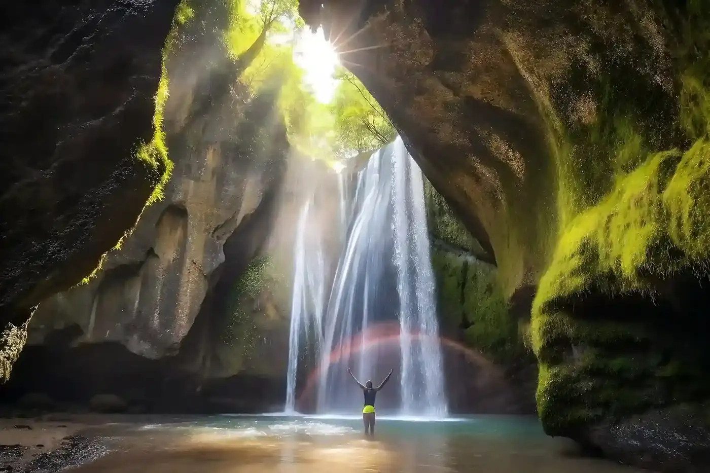 Sunlight falling into the Tukad Cepung waterfall cave in Bali