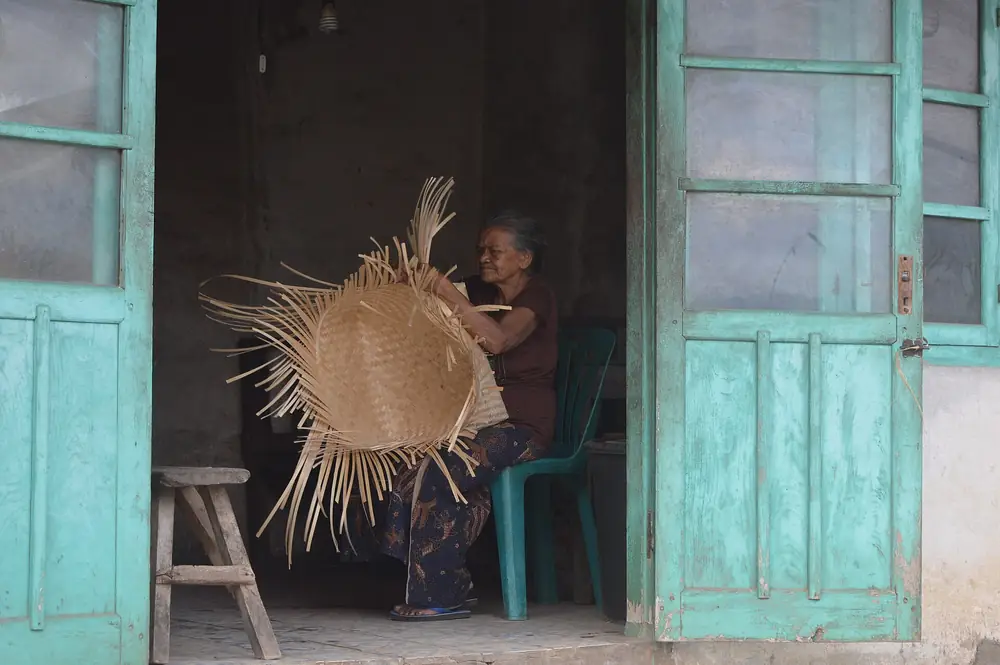 Villager weaving bamboo by hand in North Bali