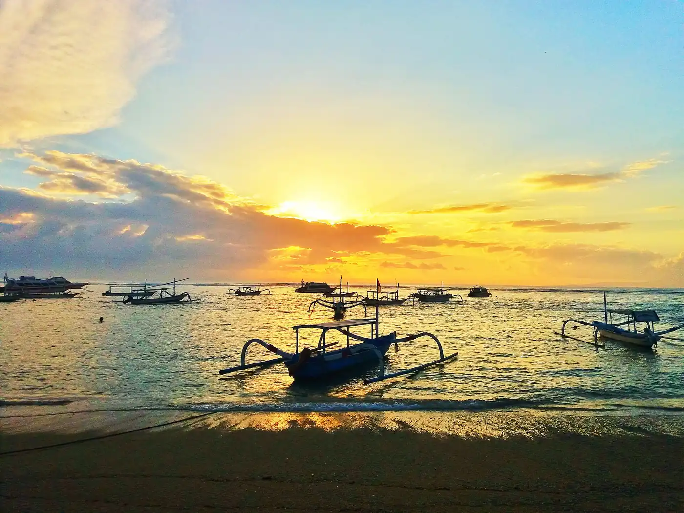 Morning on Sanur Beach with traditional jukung boats