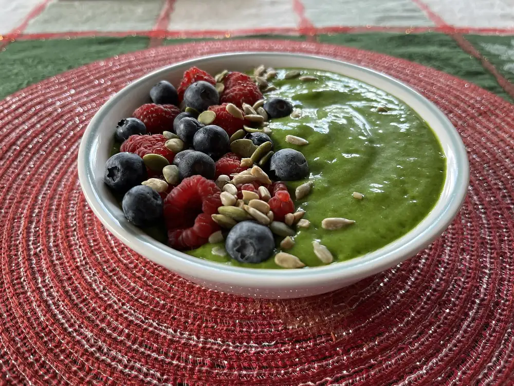 Green smoothie bowl with berries and seeds
