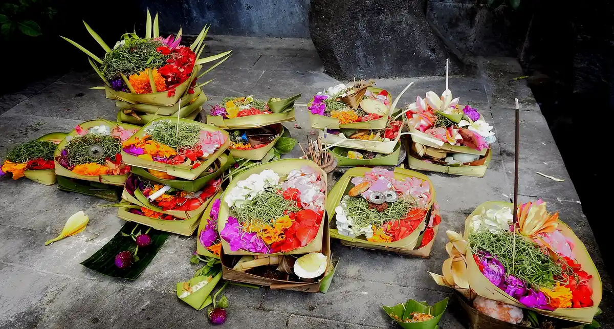 Canang sari offerings with flowers and incense