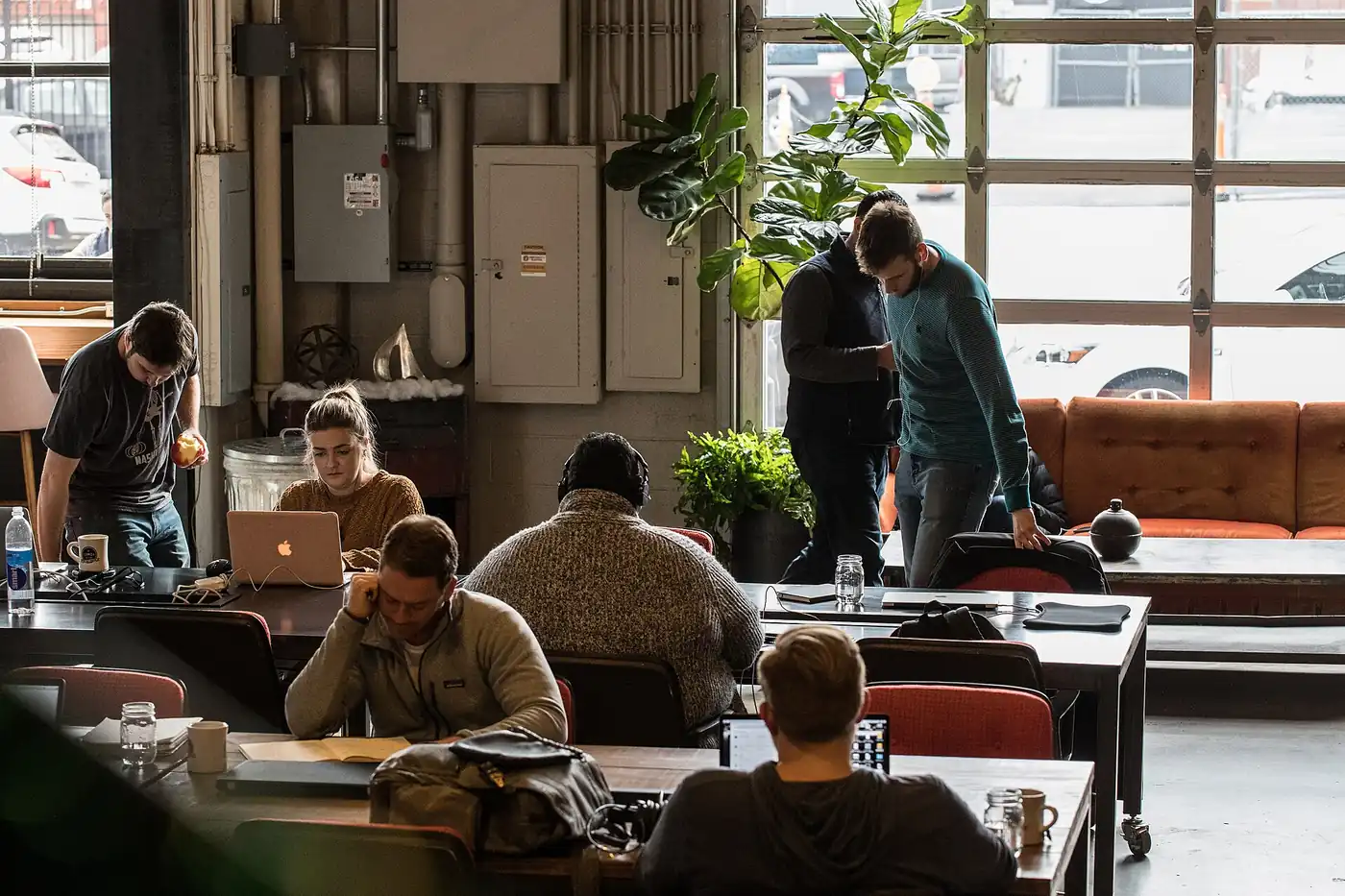 Remote workers at laptops in a coworking space